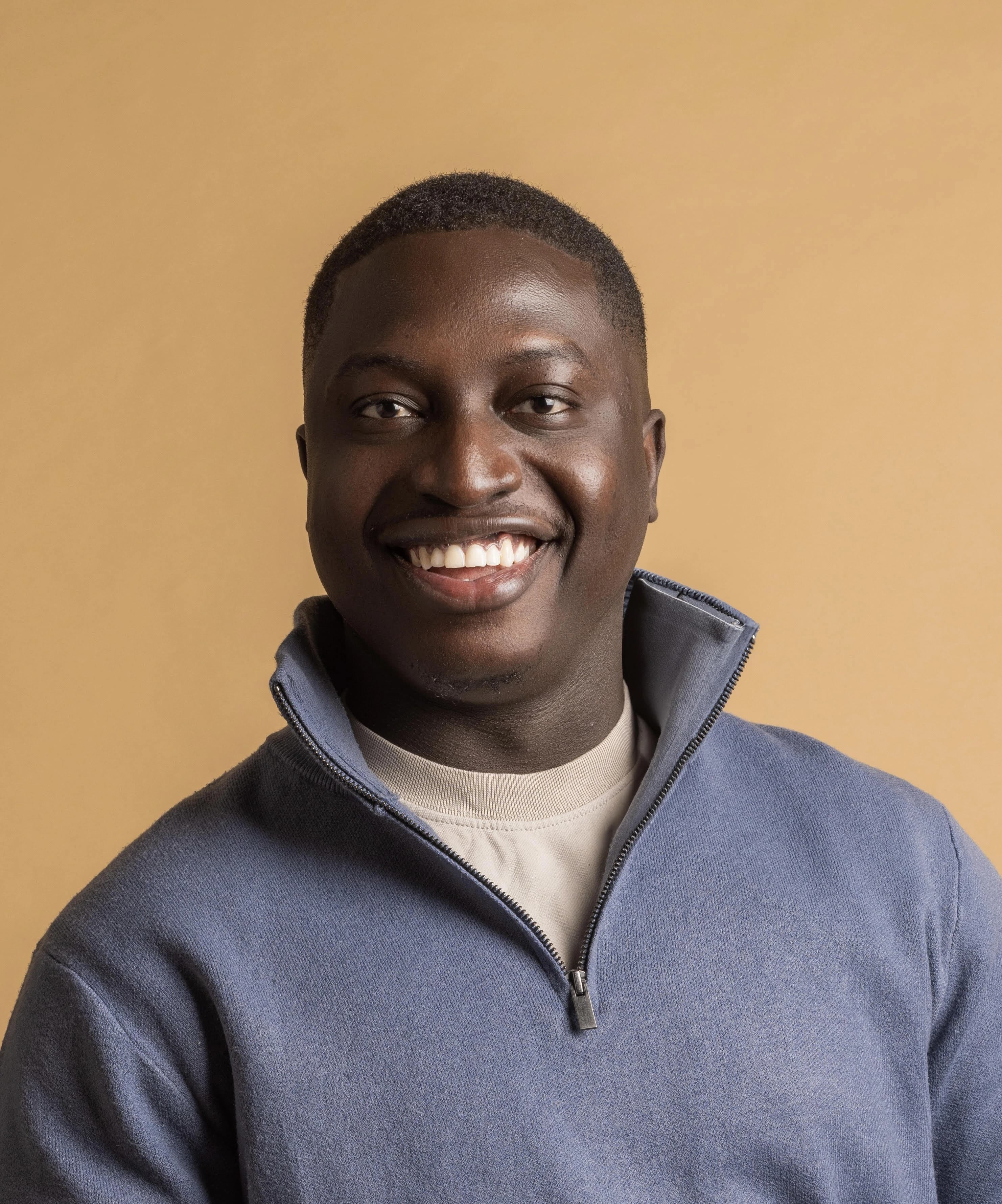 Iseunife Ajayi, Founder of The AI Colony, working on a laptop